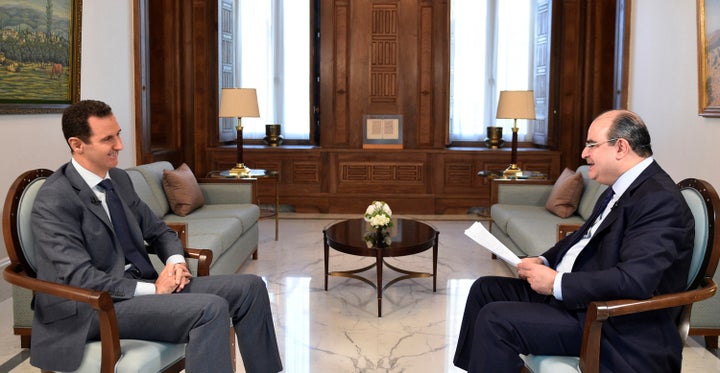 Syria's President Bashar al-Assad (L) attends an interview with al-Watan newspaper in Damascus, Syria, in this handout picture provided by SANA on December 8, 2016.