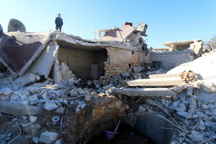 A man inspects a site hit by what residents said were airstrikes carried out by the Russian air force in the town of Turmanin, in Idlib Governorate near the Syrian-Turkish border, January 25, 2016.