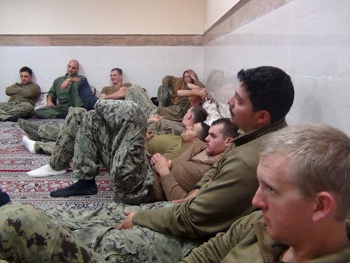 An undated picture released by Iran's Revolutionary Guards website shows American sailors sitting in an unknown place in Iran.