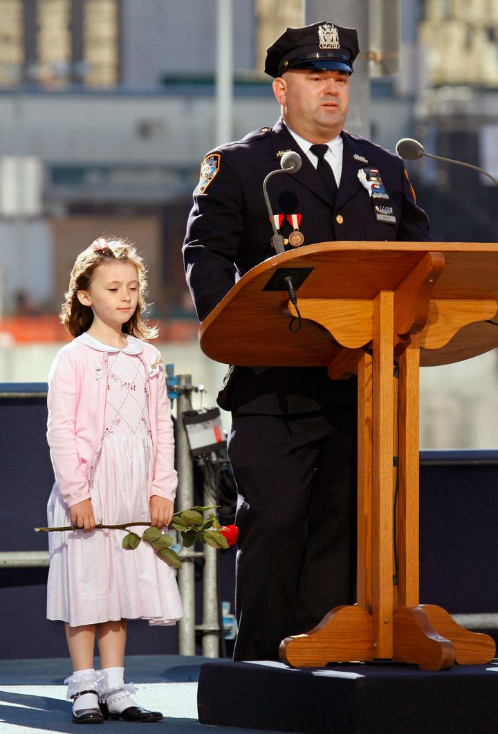 New York City policeman James Smith is seen beside his 7-year-old daughter, Patricia Smith, during the fifth anniversary of the 9/11 World Trade Center attacks which killed his wife and fellow police officer Moira Smith.