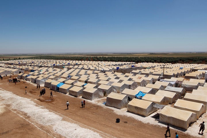 People who have been displaced due to the fighting between rebels and the forces of Syrian President Bashar al-Assad walk at the Bab Al-Nour internally displaced persons (IDP) camp, north of Aleppo