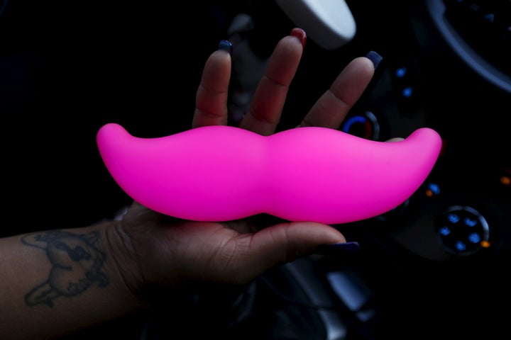 Maya Jackson, a Lyft driver from Sacramento, holds a Lyft Glowstache in San Francisco, California February 3, 2016.