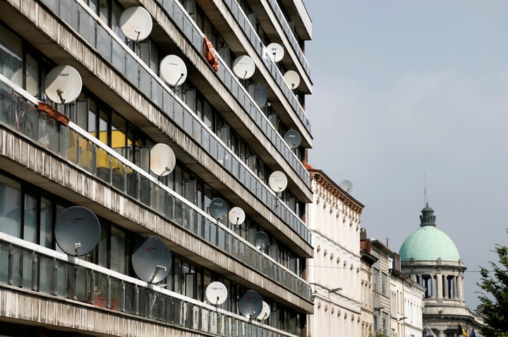 Television satellite dishes are pictured on an apartment building in the Brussels district of Molenbeek, Belgium, August 14, 2016.