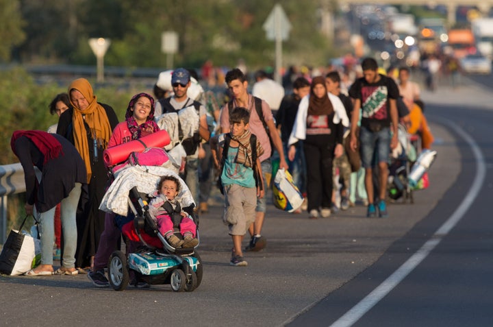 Migrants begin walking towards the Austrian border on September 4, 2015 in Bicske, near Budapest, Hungary.