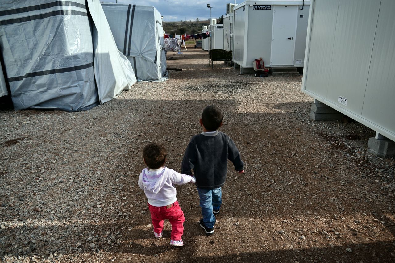 Children walk at the Ritsona refugee camp, north of Athens, on December 21, 2016.