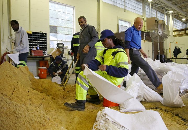 Alexandria, Virginia, public works employees load sandbags after Hurricane Joaquin battered the Bahamas.