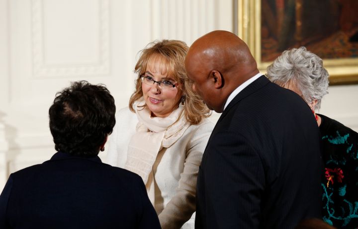 Former Rep. Gabby Giffords (D-Ariz.) gets a standing ovation as she arrives at the White House to hear Obama lay out his executive actions on gun control.
