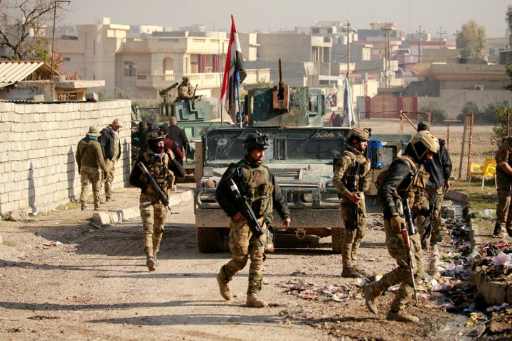 Iraqi rapid response forces gather during battle with Islamic State militants in the Mithaq district of eastern Mosul, Iraq,