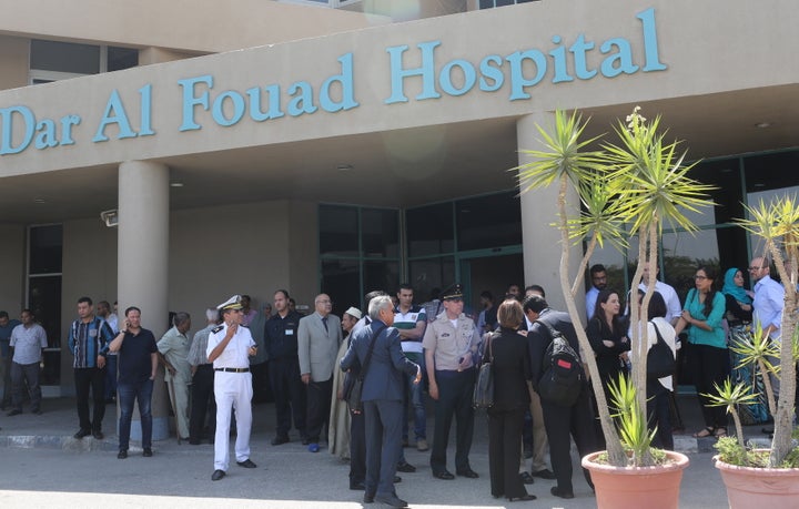 Police and Mexican embassy members stand outside Dar Al Fouad Hospital, where injured tourists who were mistakenly targeted i