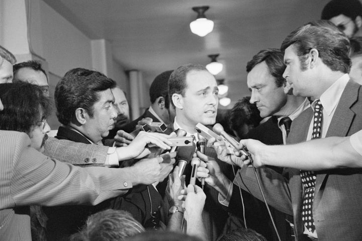 A crowd of reporters surround Los Angeles prosecutor Vincent Bugliosi as he leaves the courtroom in the trial of Charles Manson.