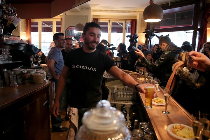 People drink inside 'Le Crillon' bar as it reopens on January 13, 2016 in Paris, France.