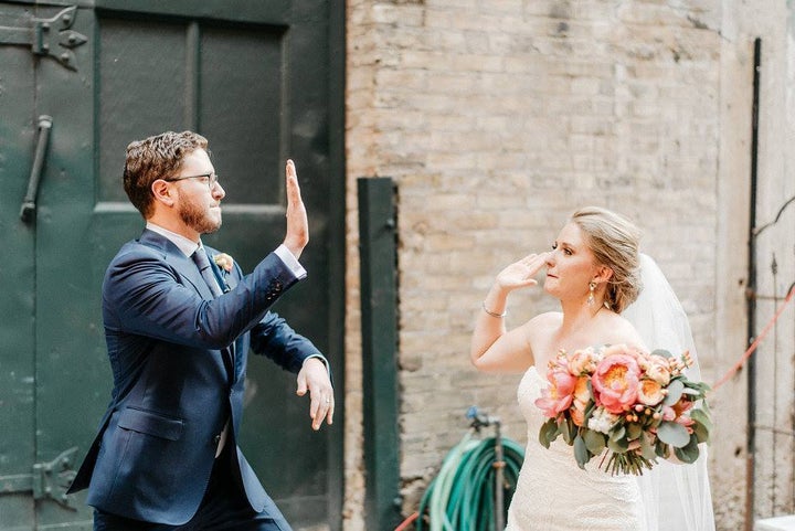 Our wedding day, celebrated with a high five. Photo by Geneoh Photography.