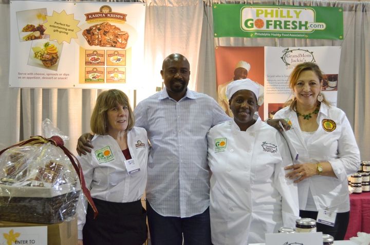 Herman Nyamunga poses with three “food entrepreneurs”—Arlene, Jackie, and Hoda—whom he has been coaching.