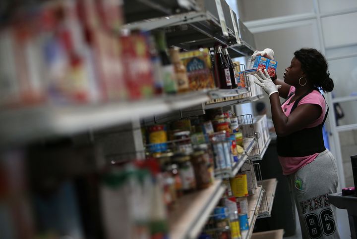 A worker stocks shelves with canned goods at the SF-Marin Food Bank in San Francisco, California. Food banks could become strained, as more than 500,000 people could lose food stamps in 22 states reinstating work requirements.