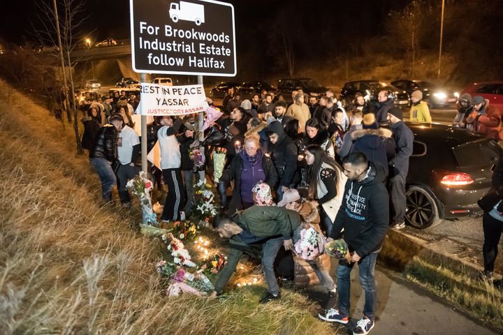 Mourning friends and family hold a vigil at Jct 24 of the M62 near Huddersfield, West Yorks.