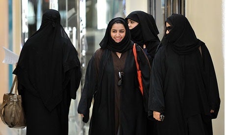 Saudi women walk inside the Faysalia shopping center in Riyadh, the capital.