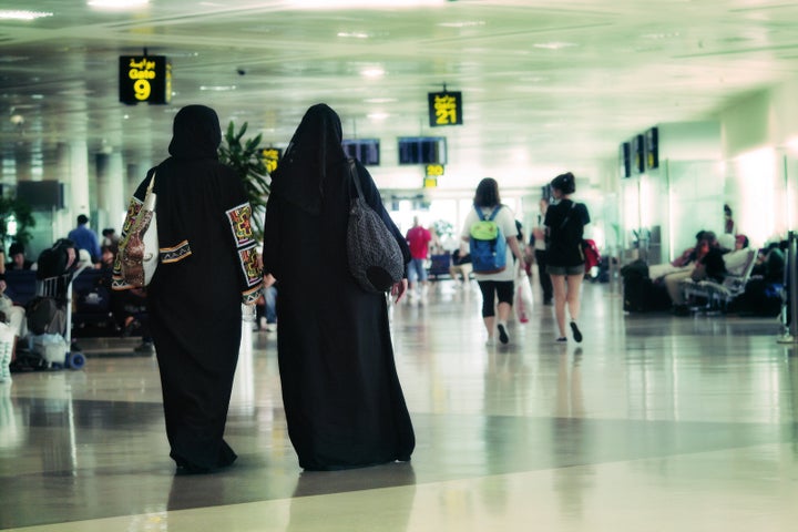 Women walking at the old airport in Doha, Qatar.