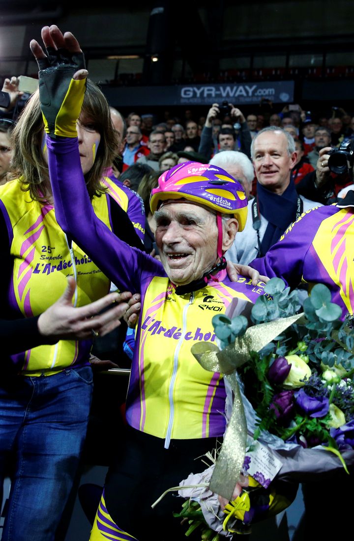 The 105-year-old waves to fans gathered at the French track.