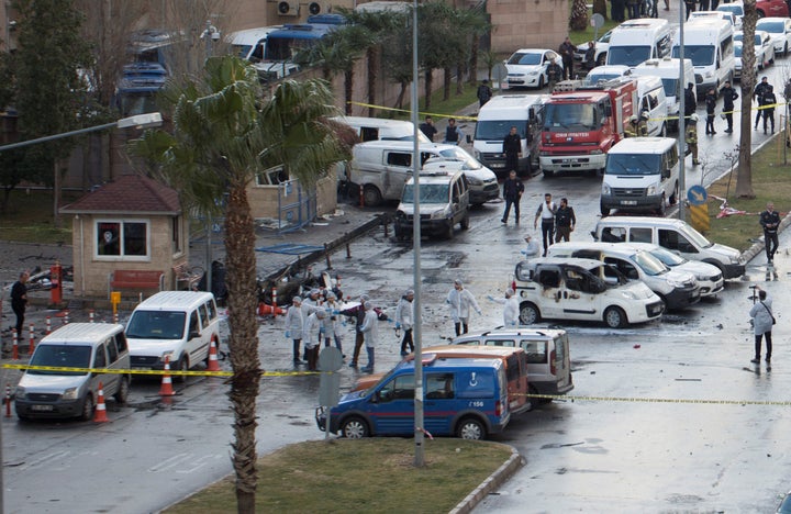 Police forensic experts examine the scene