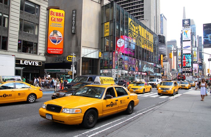 Yellow cabs travel south on Broadway in Times Square in New York.