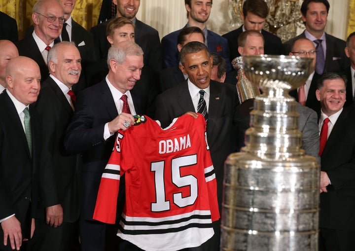 Obama with the team jersey he received as a gift from the Blackhawks.