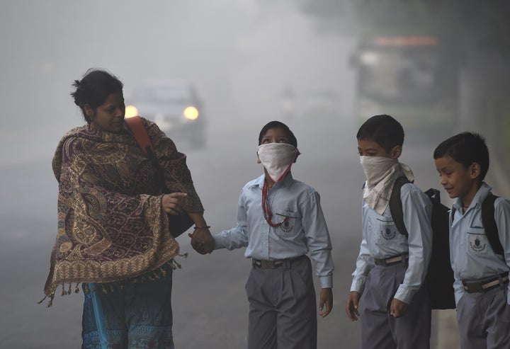 Schoolchildren cover up against the heavy smog in New Delhi, India, on Nov. 3, 2016.