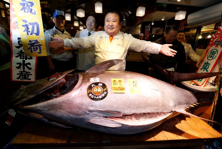 Kiyoshi Kimura poses with a 467-pound bluefin tuna at his sushi restaurant outside Tsukiji fish market in Tokyo, Japan.