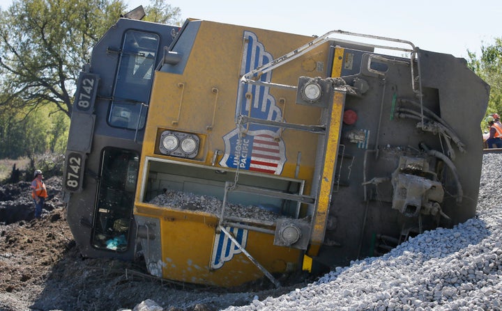 A Union Pacific train engine sits on its side waiting to be uprighted after the train was derailed by floodwaters near Corsic