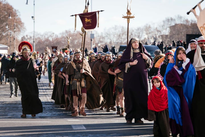 People walk along via della Conciliazione in Rome during a historical and folkloristic parade to celebrate the Epiphany. Rome, 6th January 2017.