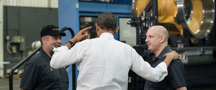 President Barack Obama talks with employees at the Linamar factory in Asheville, North Carolina, on Feb. 13, 2013.