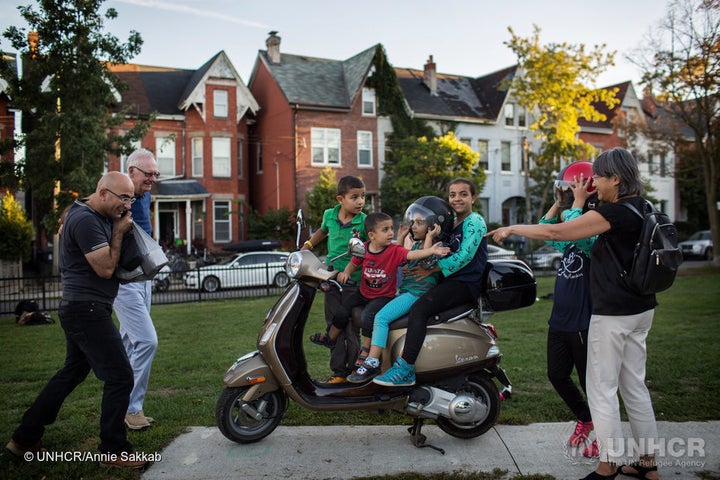 The Nouman children play on Michael Adam's Vespa.