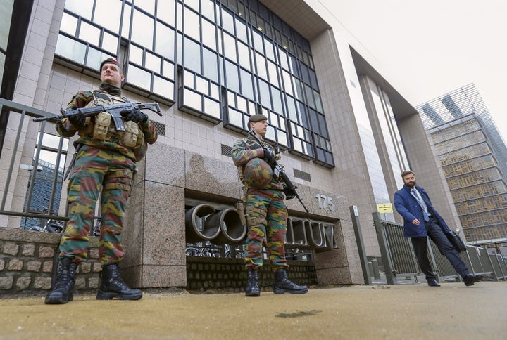 Armed soldiers stand guard outside the European Council headquarters, on Nov. 17, 2015. Salah Abdeslam, a French national who lived in Molenbeek, Belgium, is currently the subject of an international manhunt after the Paris attacks.