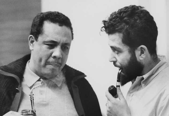 Jazz great Charles Mingus, left, smokes a pipe with a young Nat Hentoff sometime in the late 1950s or early '60s.
