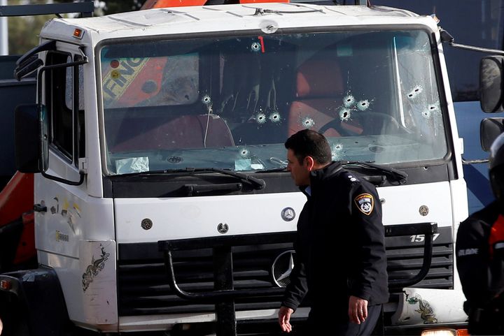 An Israeli policeman walks at the scene of a truck-ramming incident in Jerusalem January 8, 2017.
