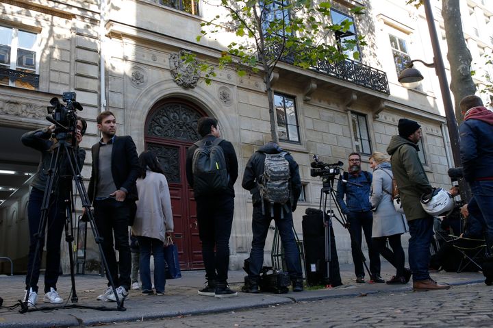 Journalists stand in front of the entrance of a luxury residence on the Rue Tronchet in central Paris where the crime was committed in October