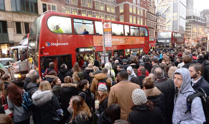 Commuters queue for buses at London's Bishopsgate at a 24-hour Tube strike led to transport chaos across the city 