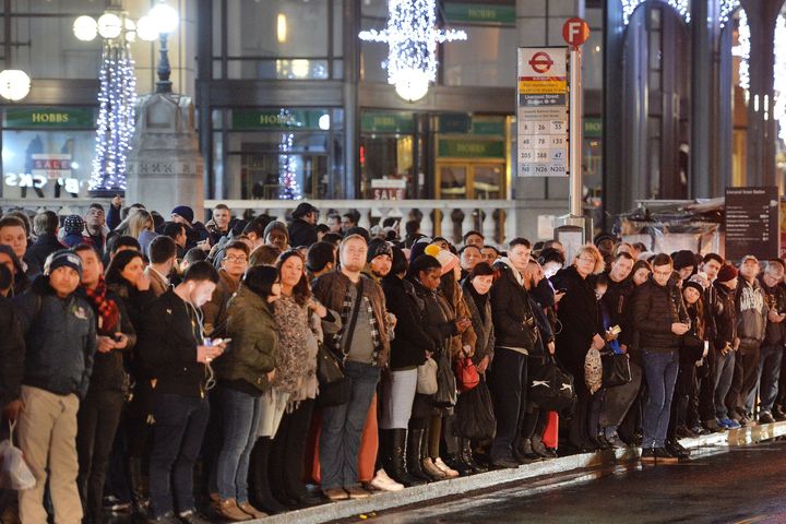 Commuters wait for buses at London's Bishopsgate