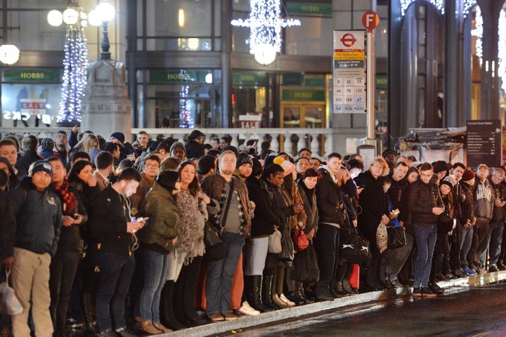 Commuters wait for buses at London's Bishopsgate