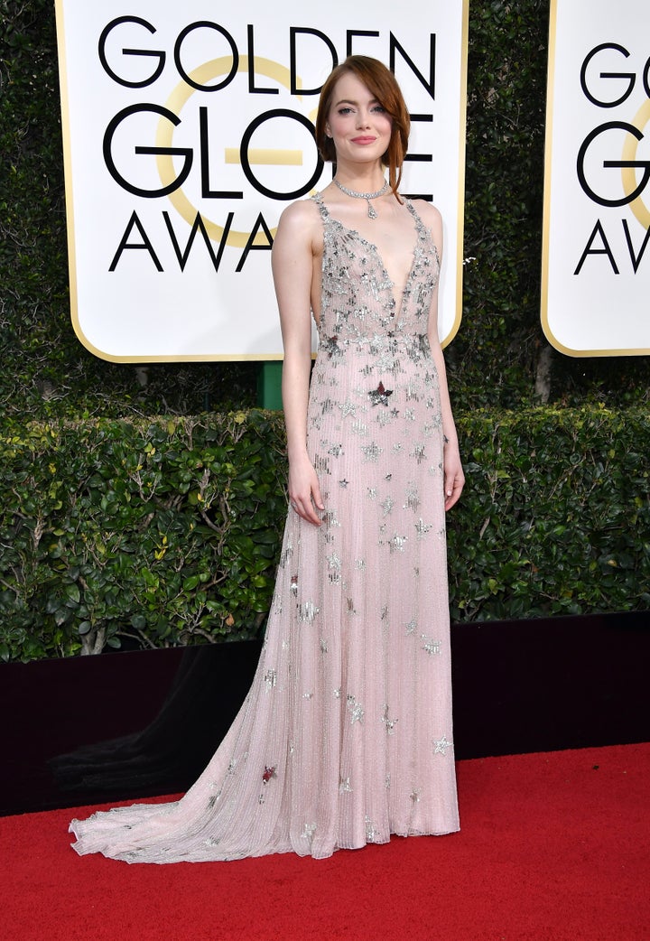 Emma Stone attends the 74th Annual Golden Globe Awards in a pink dress. 