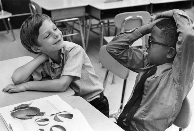 A black and white student get acquainted on their first day together at a desegregated school in 1969....