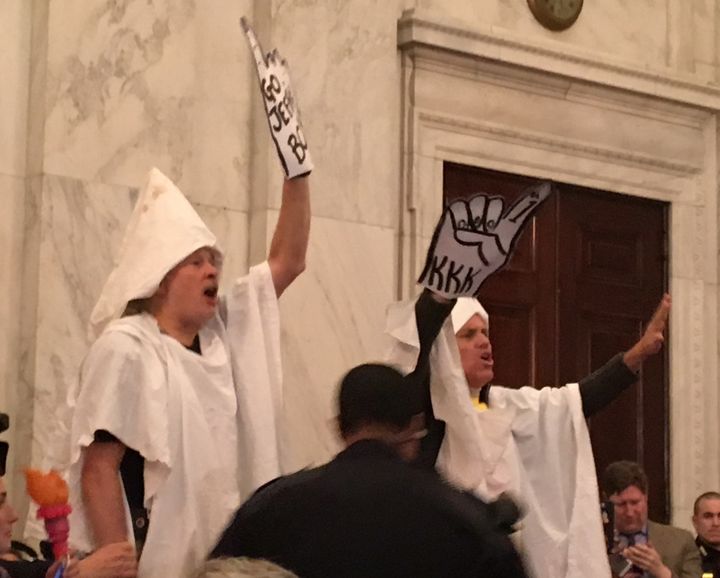Protesters dressed as members of the Ku Klux Klan greet Sen. Jeff Sessions at his attorney general confirmation hearing Tuesday.
