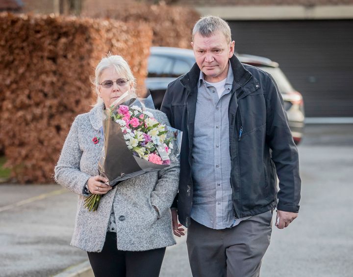 The grandparents of the victim with a floral tribute 