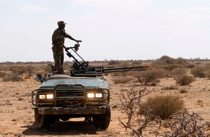 A Somalia government soldier patrols on a vehicle in the area south east of Dusamareeb, March 19, 2014.