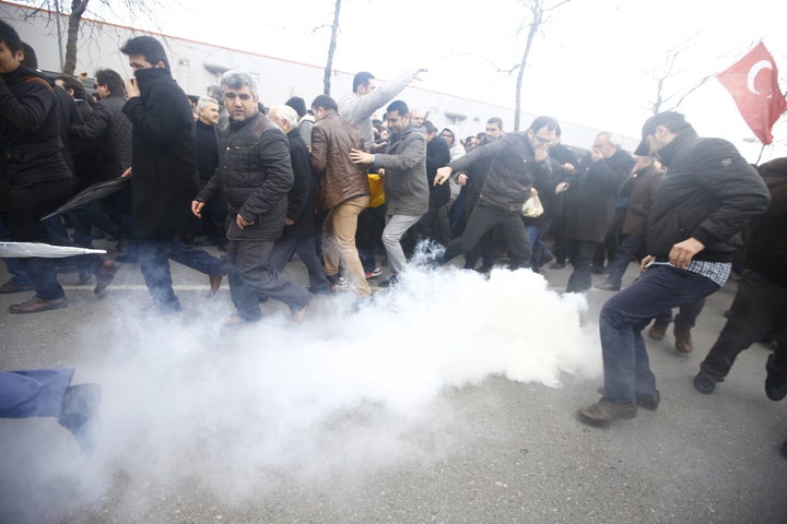 Riot police use tear gas to disperse protesting employees and supporters of Zaman newspaper at the courtyard of the newspaper