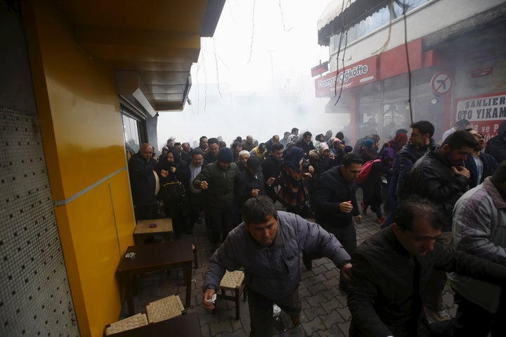 Riot police use tear gas to disperse protesting employees and supporters of Zaman newspaper at the courtyard of the newspaper