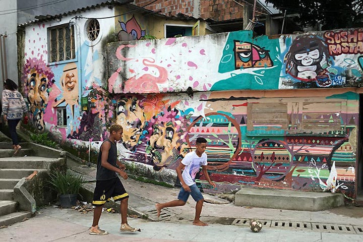 Soccer in Vidigal Favela with a mural by Andre Kajaman (one of the MOF founders) and Tarm1. Rio De Janeiro, Brazil. 