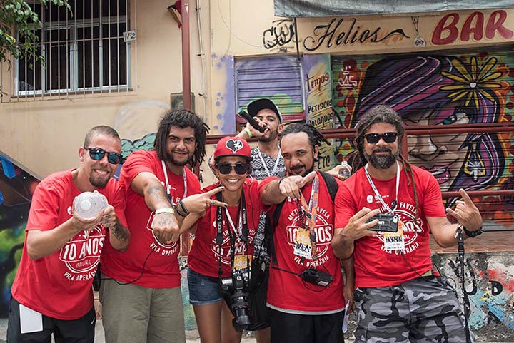 <p>From let to right: Vinicius Spam – MOF Team, Nextwo Viniius – MOF Team, Clarissa Piveta – Producer and photographer, Rafael Cruz – MOF Team, Andre Kajaman MOF Co-cofounder (Carlos Bobi is the other co-founder and is not in the picture) In the background holding a mic is Bruno Napo – MOF Team. Meeting Of Favela 2016. Favela Operaria. Duque de Caxias. Rio De Janeiro, Brazil. </p>
