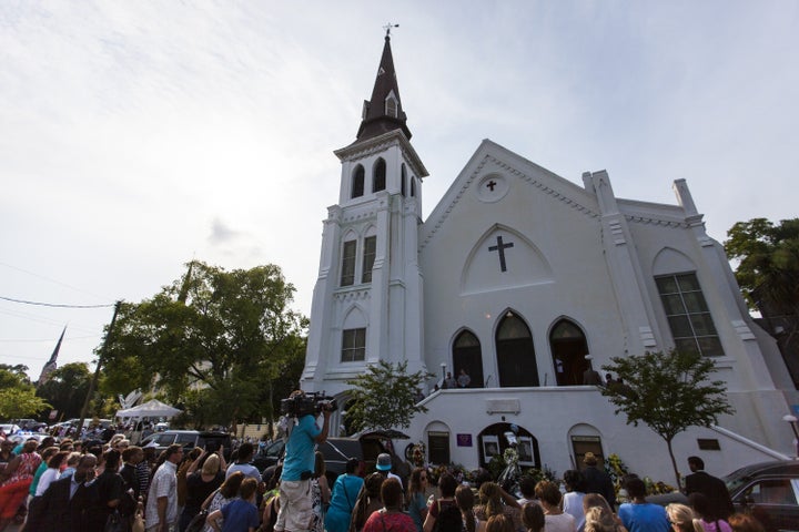 Mourners gather in front of Emanuel African Methodist Episcopal Church,where Dylann Roof murdered nine black people. "In