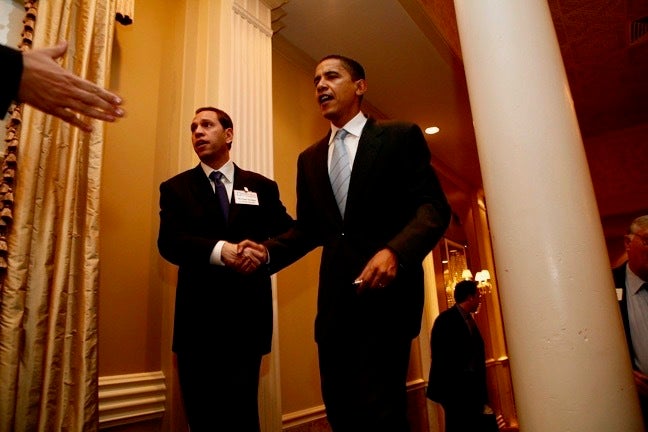 U.S. Senator Barack Obama is shown to the stage by U.S. Rep. Melissa Bean’s campaign manager, Michael Golden.