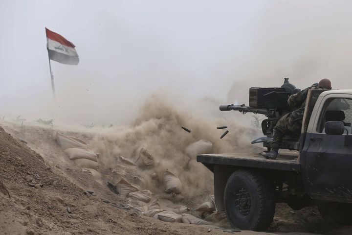 Iraqi fighters from the Shiite Muslim Al-Abbas popular mobilization unit battling in an area near the village of Dujail in the Salaheddin province. 